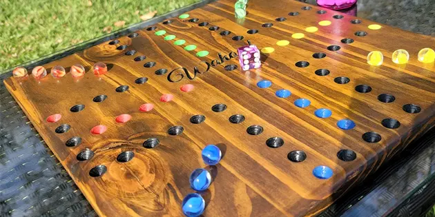 Wahoo game board layout with marbles and a single die